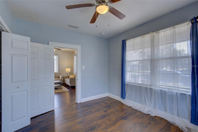 unfurnished room featuring dark hardwood / wood-style floors and ceiling fan