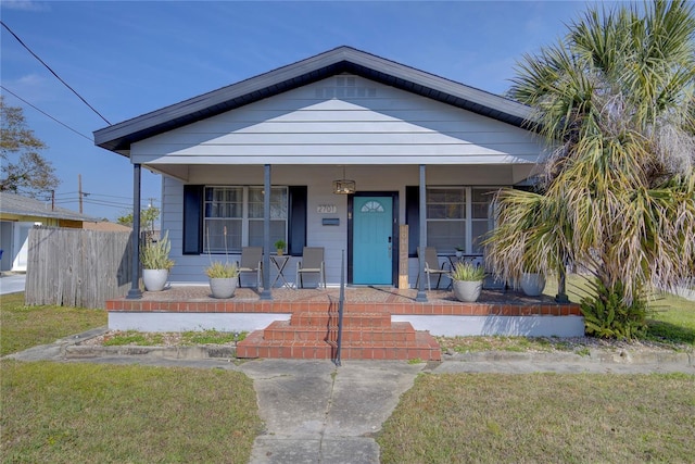 bungalow-style home with a porch and a front yard