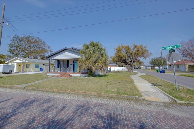 view of front of home featuring covered porch and a front lawn