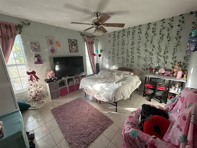 tiled bedroom featuring ceiling fan and a textured ceiling