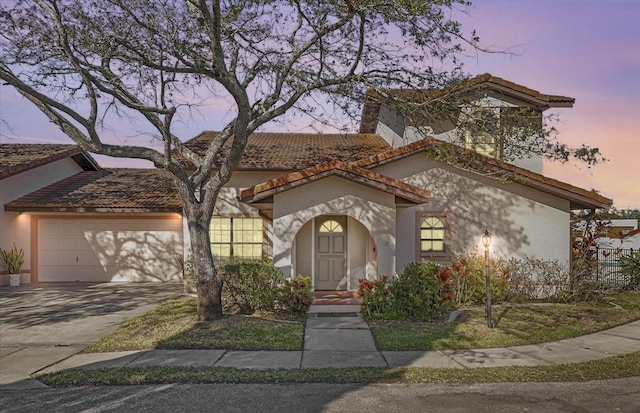 mediterranean / spanish home featuring a garage