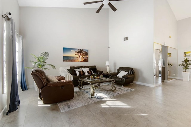 living room with ceiling fan and high vaulted ceiling