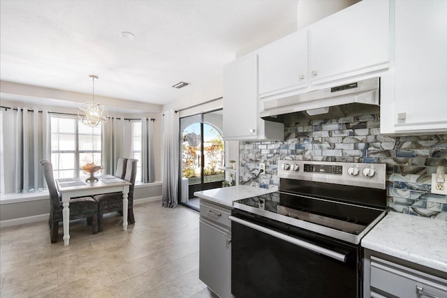 kitchen with decorative backsplash, stainless steel electric range oven, and white cabinets