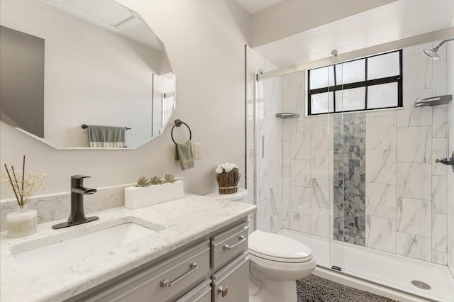 bathroom featuring toilet, vanity, and walk in shower