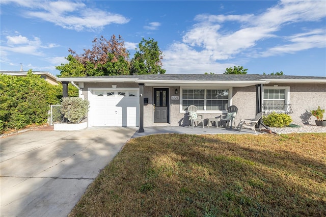 ranch-style house with a garage and a front lawn