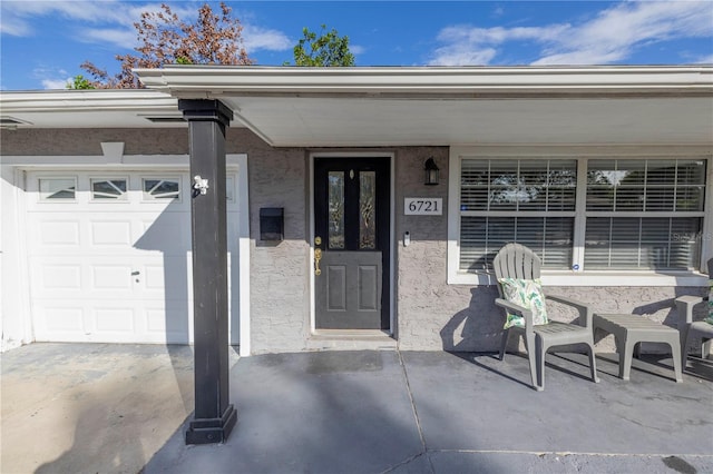 doorway to property with a garage