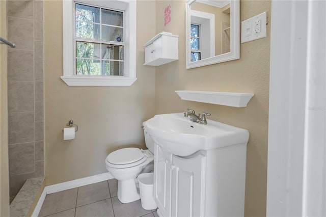 bathroom featuring tile patterned floors, vanity, toilet, and walk in shower