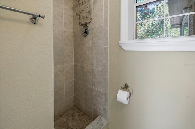 bathroom with a tile shower