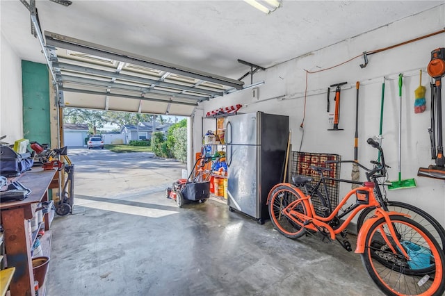 garage with stainless steel refrigerator