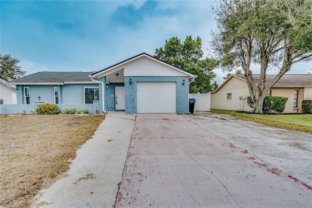 single story home featuring a garage and a front yard