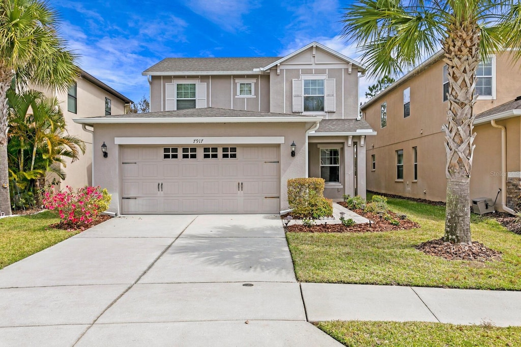 view of front of house featuring a garage and a front lawn