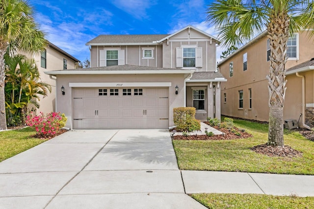 view of front of house featuring a garage and a front lawn