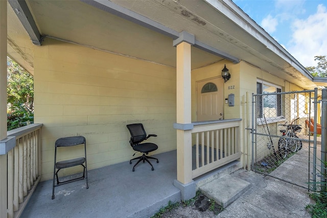 view of exterior entry with covered porch