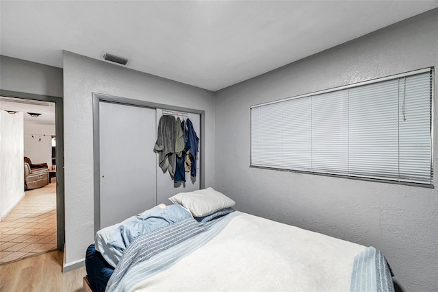 bedroom featuring a closet and light hardwood / wood-style flooring