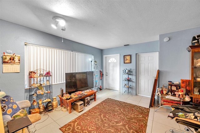 living room with light tile patterned floors and a textured ceiling