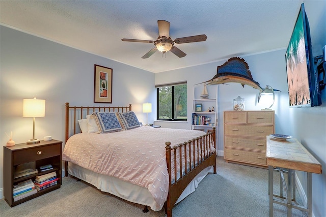 carpeted bedroom featuring a textured ceiling and ceiling fan