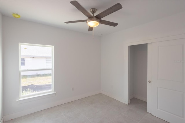 unfurnished bedroom with a closet and ceiling fan