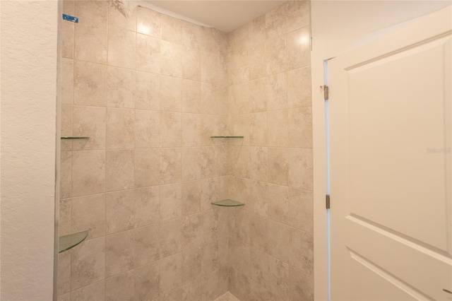 bathroom with a tile shower