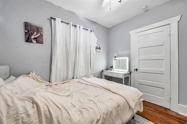 bedroom with dark hardwood / wood-style floors and ceiling fan