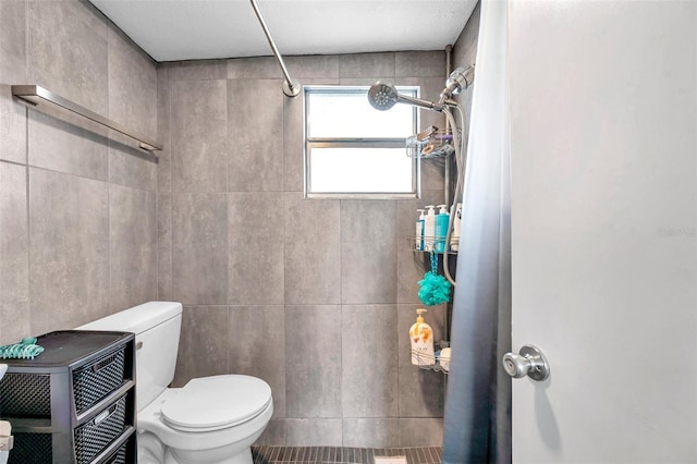 bathroom featuring toilet and a shower