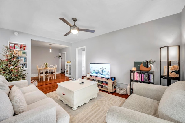 living room featuring ceiling fan and light hardwood / wood-style floors