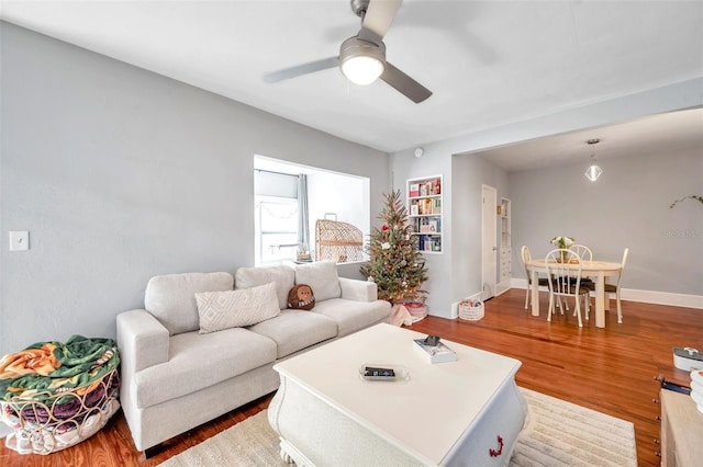 living room with ceiling fan and hardwood / wood-style flooring