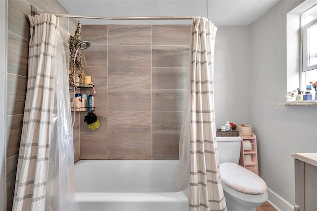 bathroom featuring shower / bath combination with curtain and toilet