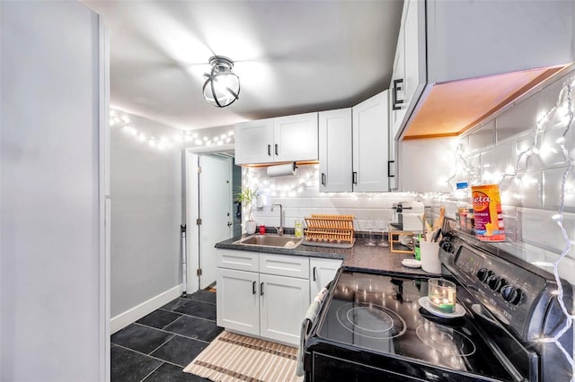 kitchen featuring backsplash, white cabinetry, black electric range, and sink