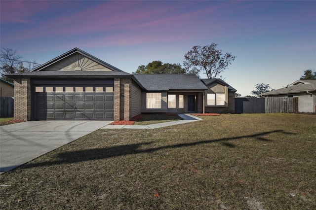 view of front facade with a yard and a garage