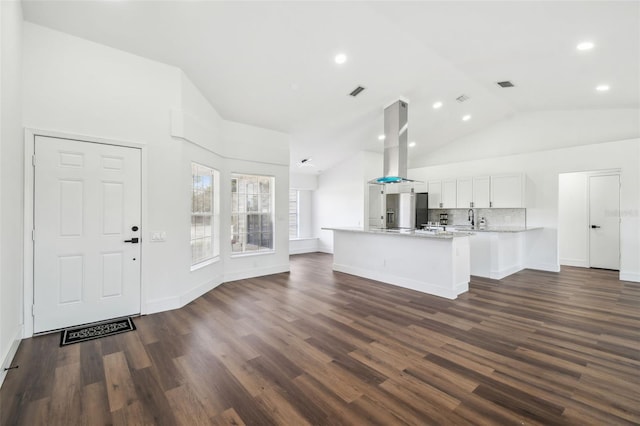 interior space featuring dark wood-type flooring, sink, and high vaulted ceiling