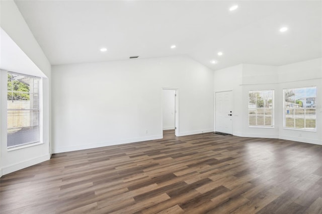 spare room featuring dark hardwood / wood-style floors and vaulted ceiling