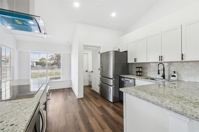 kitchen featuring lofted ceiling, sink, white cabinetry, stainless steel appliances, and light stone countertops