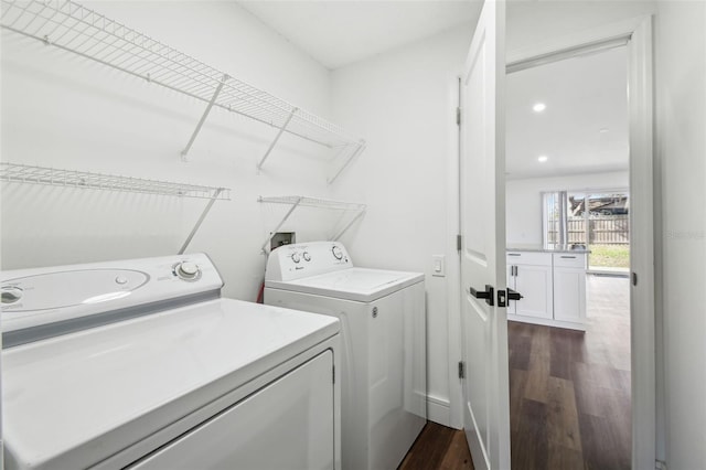 washroom featuring washing machine and clothes dryer and dark hardwood / wood-style flooring