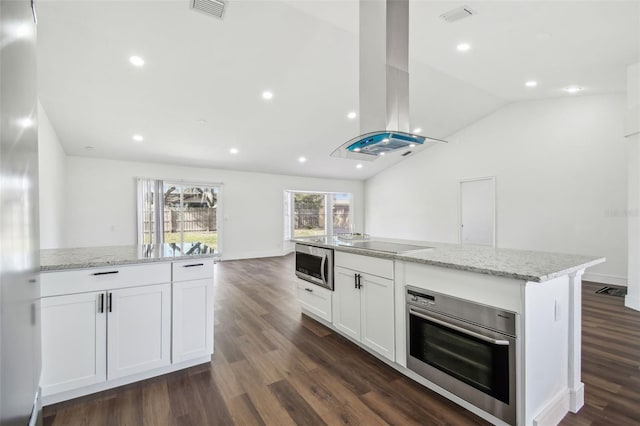 kitchen featuring appliances with stainless steel finishes, island range hood, white cabinets, and light stone counters