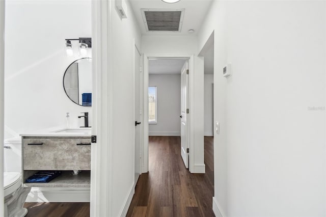 hall with sink and dark hardwood / wood-style floors