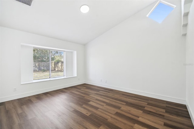 unfurnished room with dark wood-type flooring and vaulted ceiling with skylight