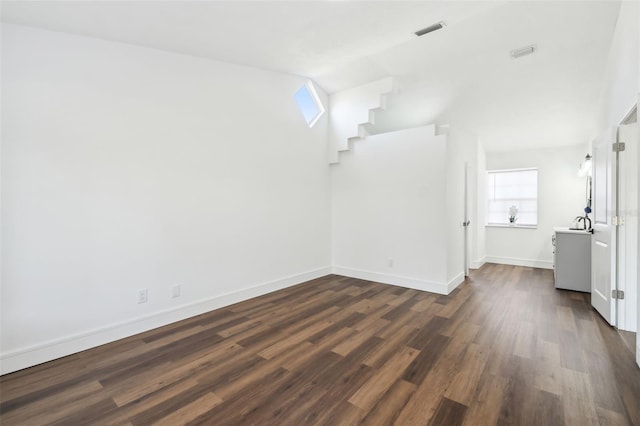 spare room with dark wood-type flooring