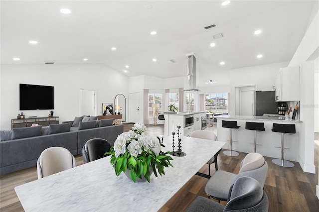 dining room with lofted ceiling and hardwood / wood-style floors