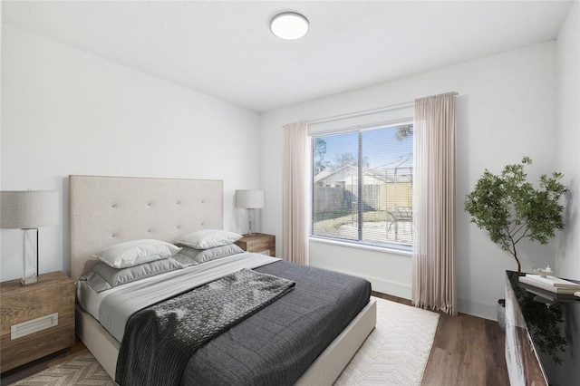 bedroom with dark wood-type flooring