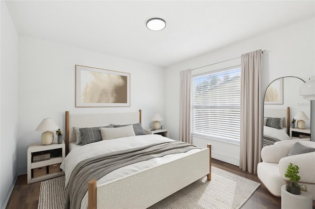 bedroom with dark hardwood / wood-style floors