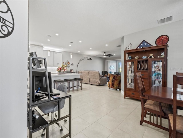 dining area with ceiling fan and light tile patterned flooring