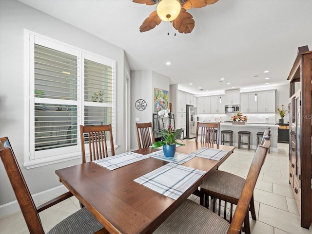 dining area featuring light tile patterned floors, a wealth of natural light, and ceiling fan