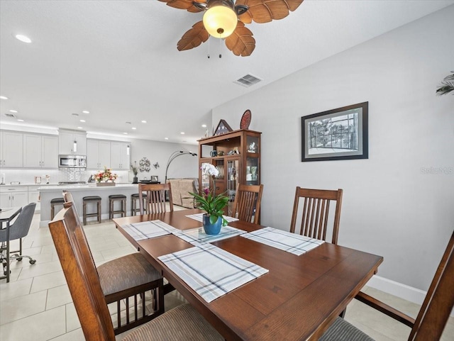 tiled dining room featuring ceiling fan