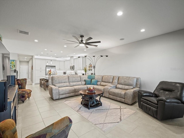 living room featuring ceiling fan and light tile patterned flooring