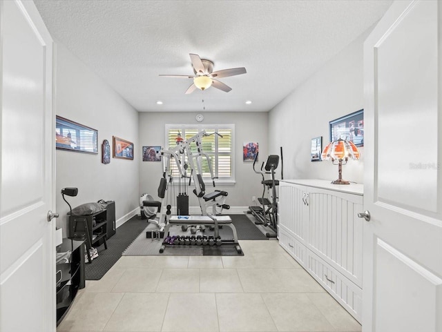 exercise area featuring a textured ceiling and ceiling fan