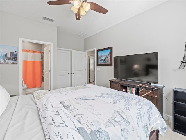 carpeted bedroom with ceiling fan and ensuite bathroom