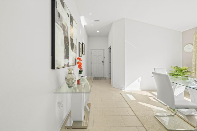 hall featuring light tile patterned flooring