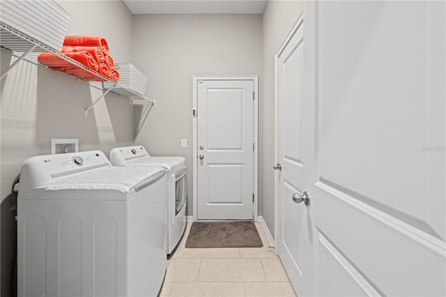 laundry room featuring light tile patterned floors and washing machine and clothes dryer