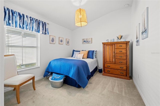 carpeted bedroom with lofted ceiling