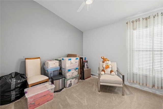 sitting room with vaulted ceiling, ceiling fan, and carpet